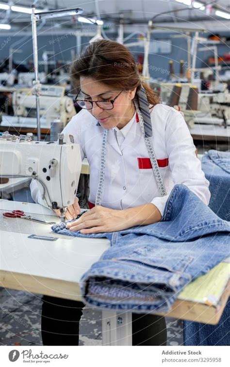 Woman S Hands In Textile Factory Sewing On Industrial Sewing Machine