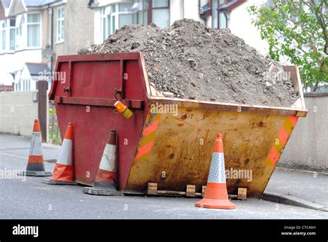 Gb rubbish skip dirt waste building rubble dispose hi-res stock