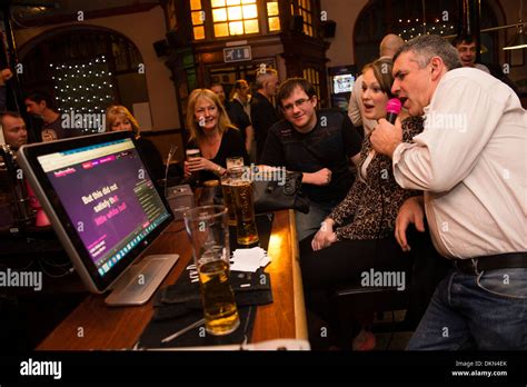 A Group Of People Friends Singing Along To A Karaoke Machine In The