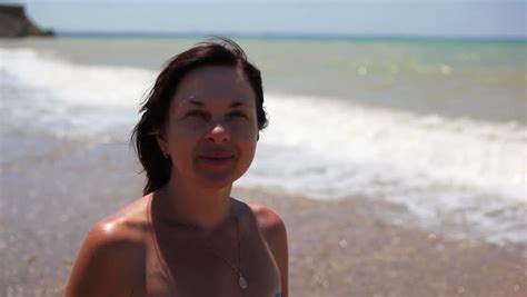 Sexy Slim Girl In Black Bikini With Rhinestones Having Fun Lying On The Shore Of The Beach In