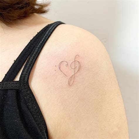 Bass And Treble Clef Heart Tattooed On The Shoulder