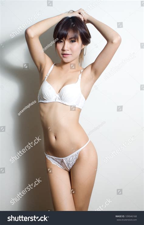 Sexy Asian Woman In White Sexy Lingerie On Red Chair Stock Photo