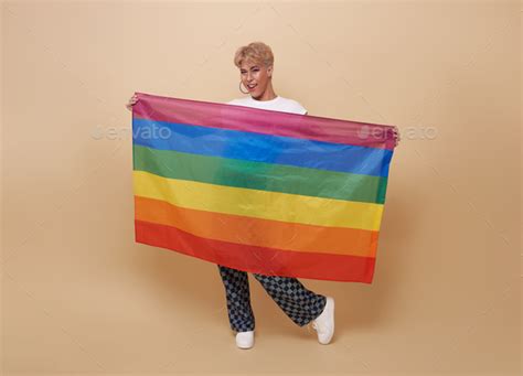 Youth Asian Transgender Lgbt Showing Rainbow Flag Isolated On Nude Color Background Stock Photo