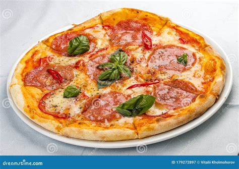 Delicious Hot Pizza With Salami Cheese Tomatoes And Various Spices