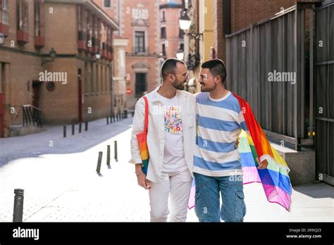 In A Sun Kissed Cityscape Two Joyful Gay Friends Illuminated By A Vibrant Sunset Proudly
