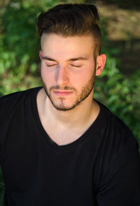 Peaceful Young Man With Eyes Closed Relaxing Outdoors In Nature Stock