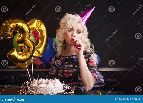 Anniversary Birthday Young Beautiful Blonde Sitting In Front Of A Birthday Cake And Sad Stock