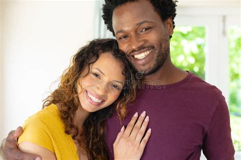 Portrait Of Smiling Young Multiracial Couple Hugging Each Other While