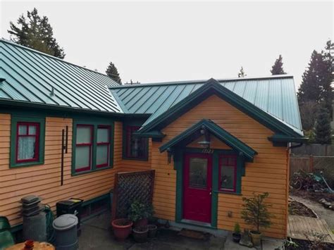 cedar siding house with green metal roof - Bret Helton