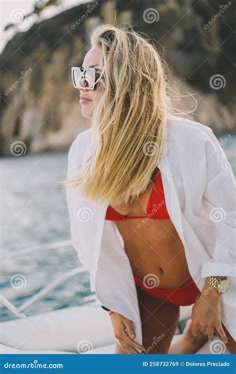 Blonde Model With A Red Bikini And Sunglasses On A Boat Ride Stock