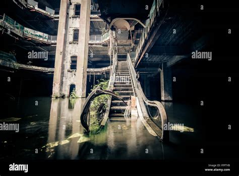 Dramatic View Of Damaged Escalators In Abandoned Shopping Mall Sunken