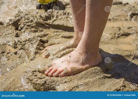 Kids Feet In Wet Sand Mud Barefeet Child Playing With Wet Sand On