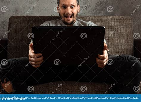 A Man Watches An Adult Video On A Laptop While Sitting On The Couch The Concept Of Porn Men S