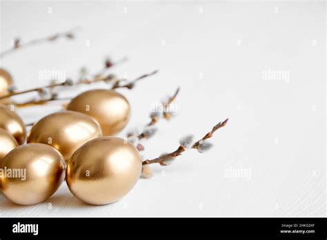 Easter Eggs With Pussy Willow Branches On White Wooden Table Happy
