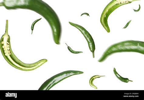 Green Chili Peppers Falling On White Background Stock Photo Alamy