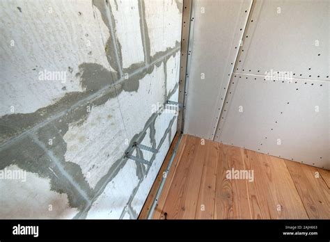 Unfinished Brick Wall In A Room Under Construction Prepared For Drywall