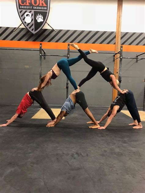 Five People Doing Yoga Poses In A Gym