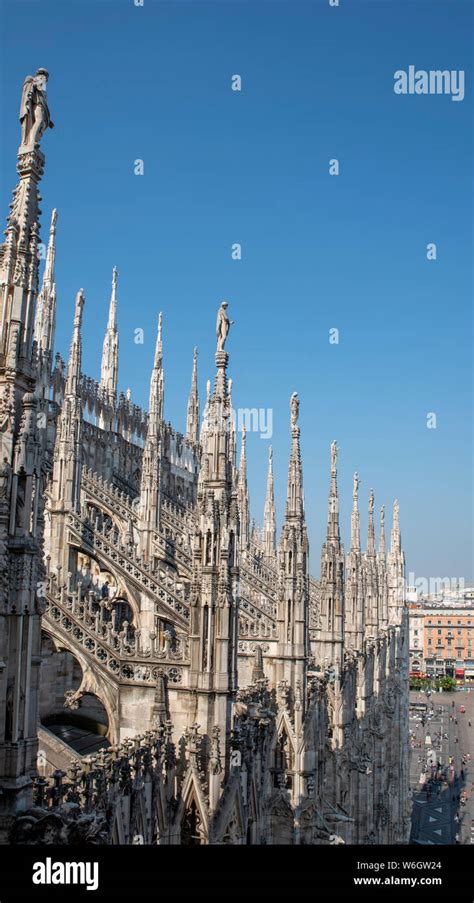 White Marble Statues On The Roof Of Famous Cathedral Duomo Di Milano On