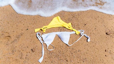 Flat Lay Picture Of White And Yellow Bikini On Sand Stock Image Image