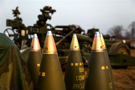 M795 high explosive projectile 155 mm rounds are prepped and staged to