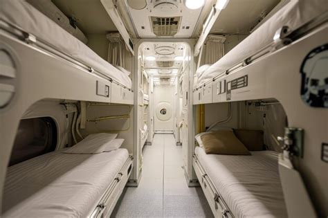 Premium Photo | Compact Sleeping Bunks Or Personal Spaces For Crew Members Define The Spacecraft ...