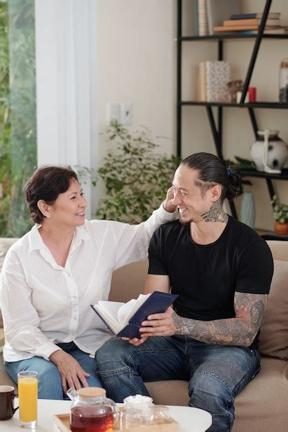 Premium Photo Mature Mother Talking To Her Elder Son While They Sitting On Sofa In The Living Room