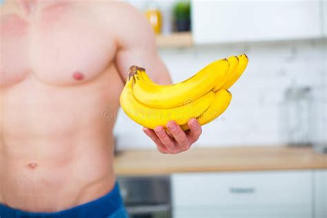 Muscular Man With A Naked Torso In The Kitchen With Fruit Concept Of Healthy Eating Athletic