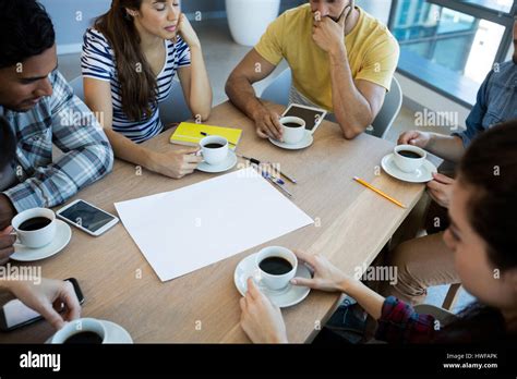 Creative Business Team Having Meeting Over Coffee In Meeting Room In