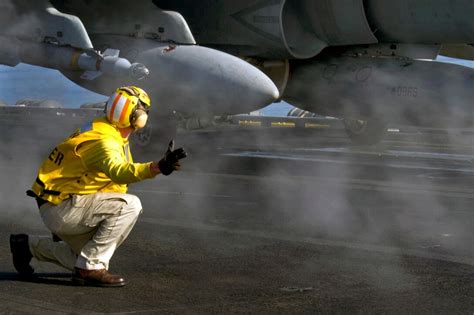 U S Navy Chief Petty Officer Matthew Scarlato Signals To Launch A U S