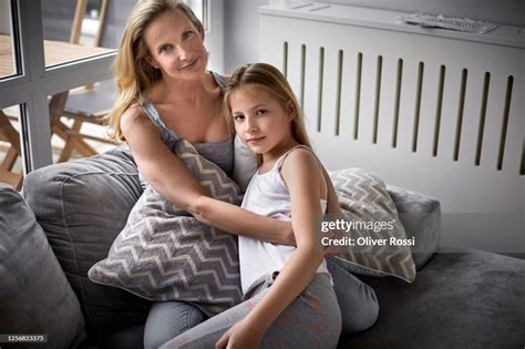 Portrait Of Affectionate Mother And Daughter On Couch In Living Room