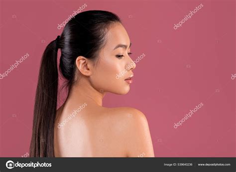 Sexy Naked Chinese Woman Posing On Purple Studio Background Stock