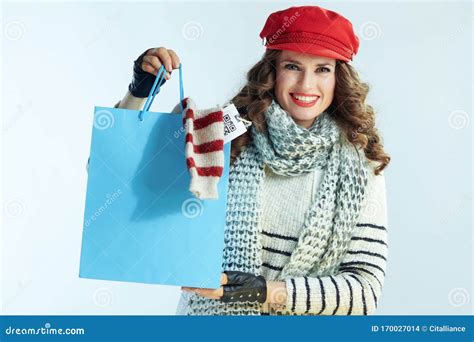 Happy Woman Showing Blue Shopping Bag With Purchased Sweater Stock