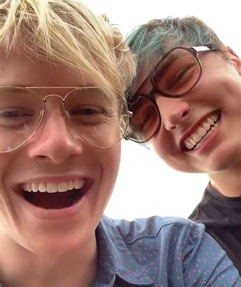 Two People With Glasses Are Smiling For The Camera