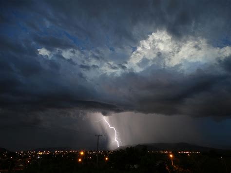 Bright lightnings with rainy clouds over ocean · Free Stock Photo