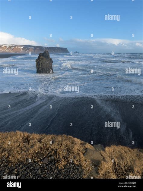 Reynisfjara Black Sand Beach And Reynisdrangar Basalt Sea Stacks As