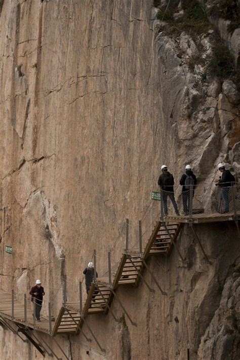 Several People Are Walking Up And Down Stairs On The Side Of A Large