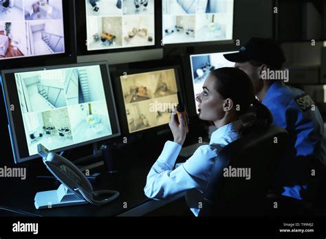 Security Guards Monitoring Modern Cctv Cameras In Surveillance Room