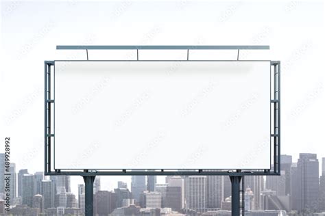 Blank White Billboard On City Buildings Background At Daytime Front