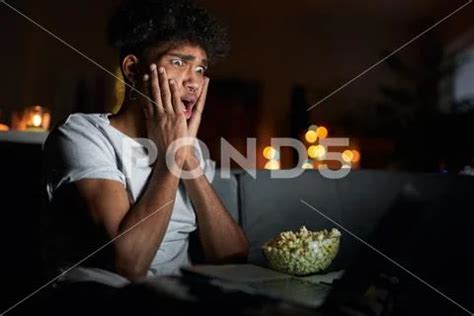 Young guy looking terrified while watching horror movie alone using laptop and ~ Premium Photo ...