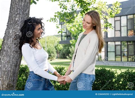 Pleased Lesbian Women Holding Hands Near Stock Photo Image Of Couple Joyful
