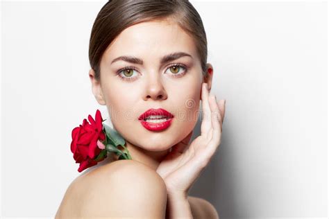 Woman With Flower Red Lips Hand Near Face Naked Shoulders Makeup Stock