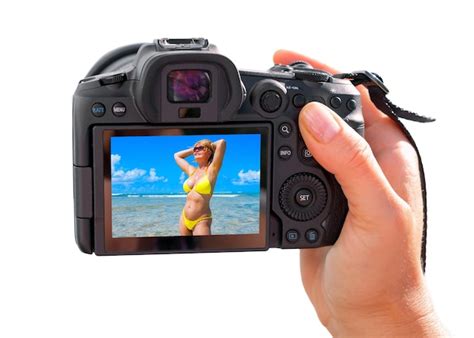 Premium Photo Photographer Holding Digital Camera In Hand And Taking Picture Of Bikini Model
