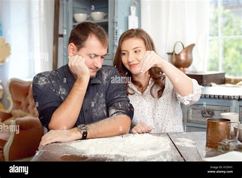 Young couple in the kitchen playing with flour. Funny moments, smiles, cooking, Happy together ...