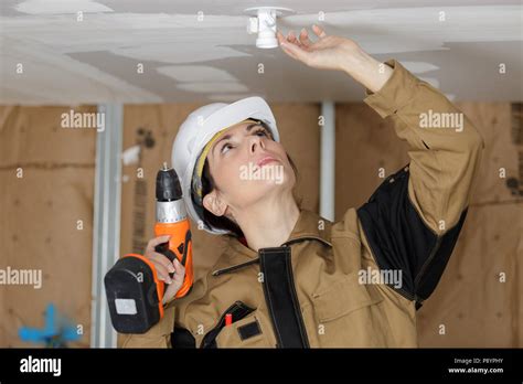 woman installing electrical outlet from the ceiling Stock Photo - Alamy