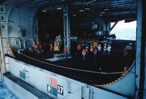 Crewmen Stand By In The Hangar Bay Aboard The Nuclear Powered Aircraft