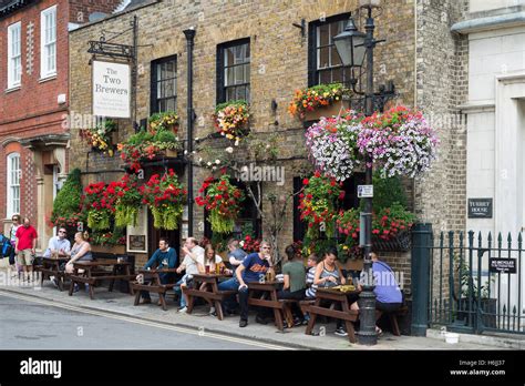 People Sitting And Drinking Outside The Premises Of The Two Brewers Pub