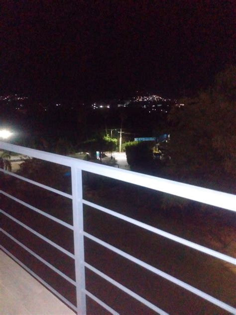 A White Fence With Some Lights On At Night