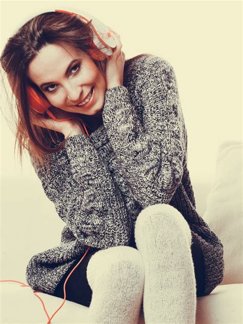 Beautiful Brunette Rich Saucy Woman In Elegant Dress Sitting On A Chair In A Room With Classic