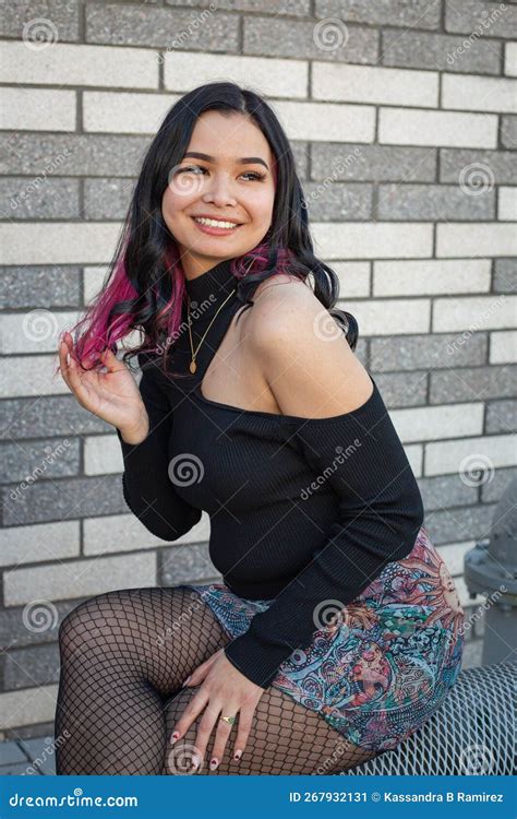 Beautiful Commercial Model With Black And Purple Hair Posing In Downtown City In Front Of Gray