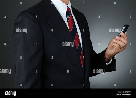 Closeup Of A Businessman Checking Messages On His Cell Phone